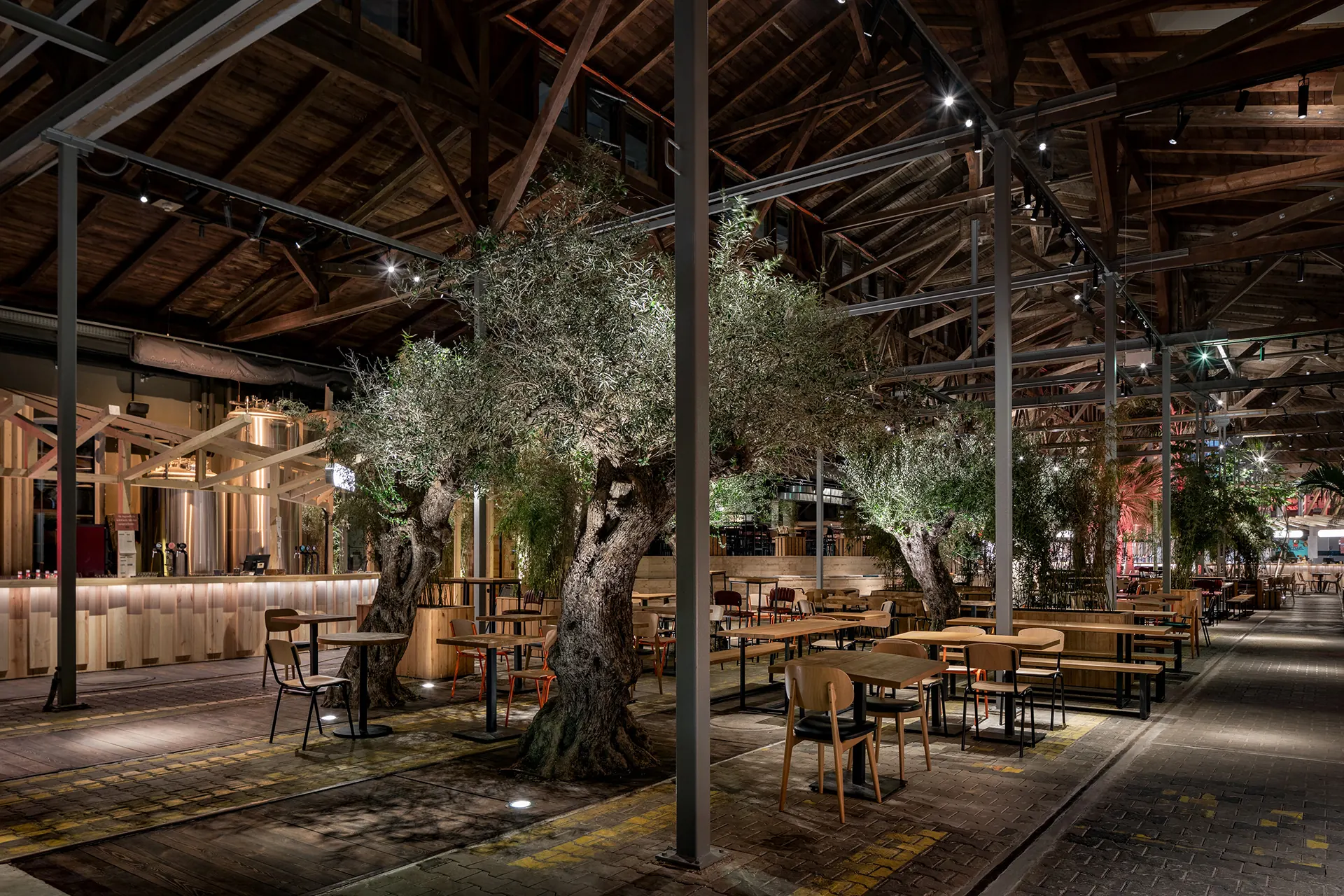 Covered outdoor dining area with timber beams, plants and intimate seating.